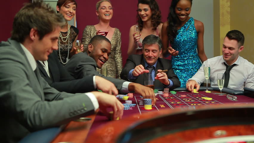 a group of people around a casino table 