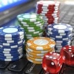 poker chips standing on a laptop keyboard