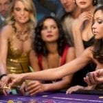a woman holding poker chips on a casino table